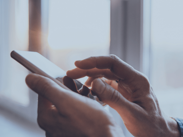 A man typing on his mobile phone