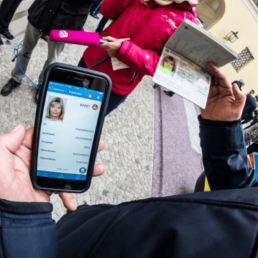 A man holding a telephone and a passport