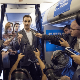 Robby Mook speaks to the traveling media corps.